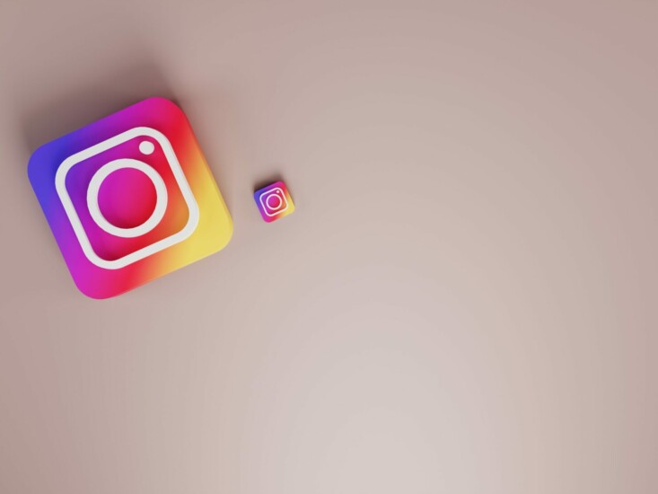Two Instagram logos on beige background