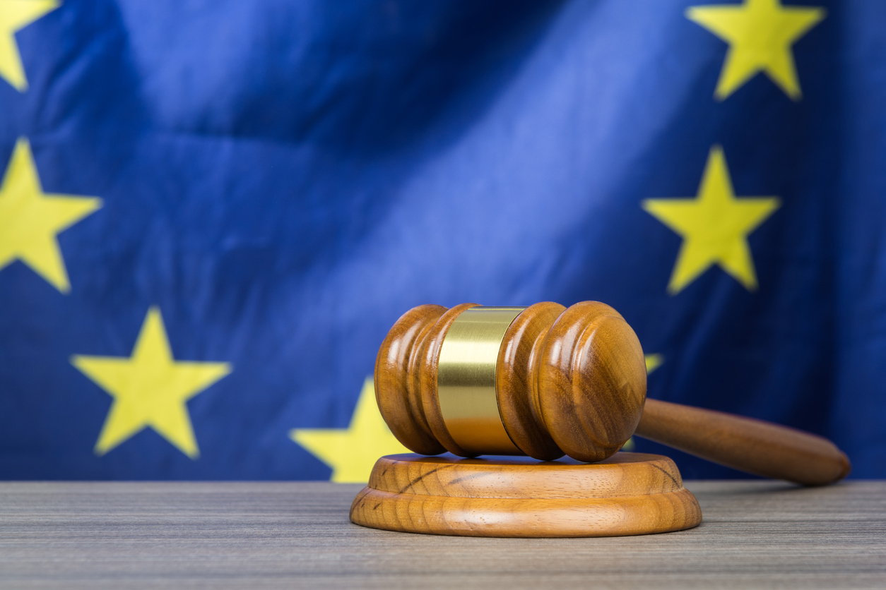 A court gavel with European Union flag in the background