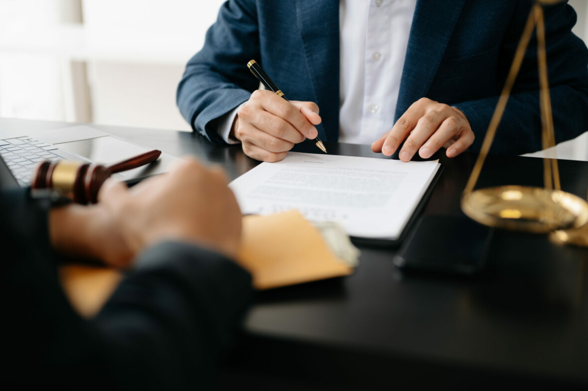 two people discussing over a paper in a legal setting