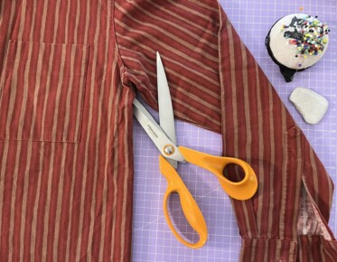 Scissors cutting a shirt