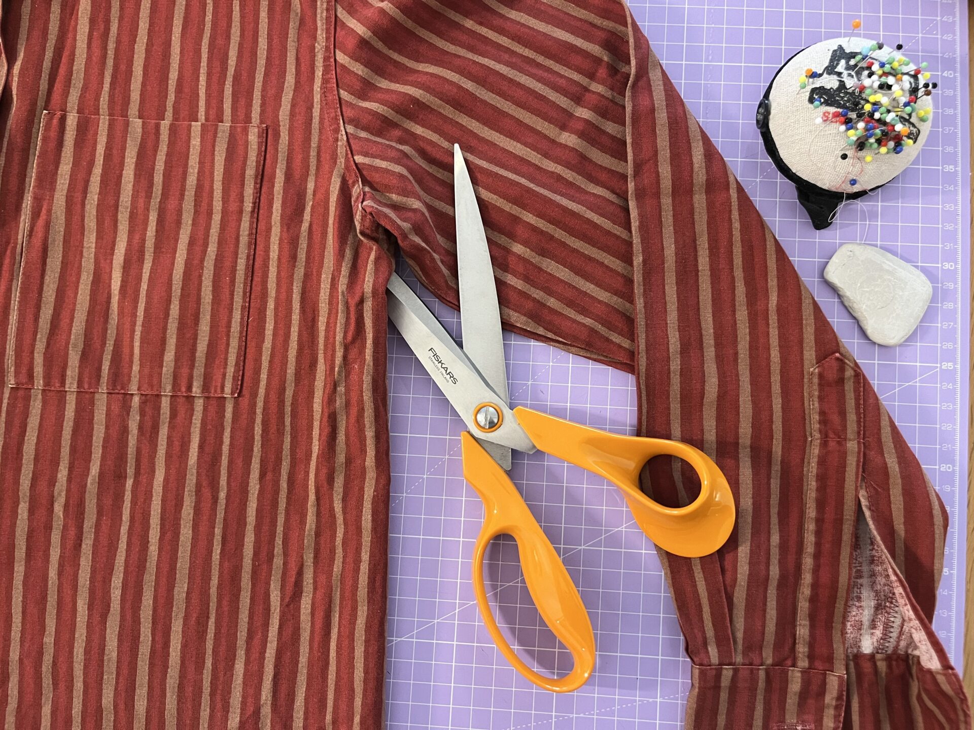 Scissors cutting a shirt