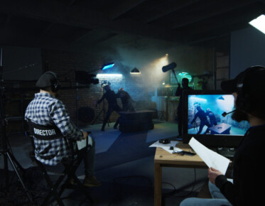 director and producer watching the actors