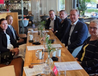 Kuva ryhmästä henkilöitä ravintolassa lounaalla.