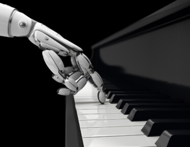 Robot plays a key on piano.