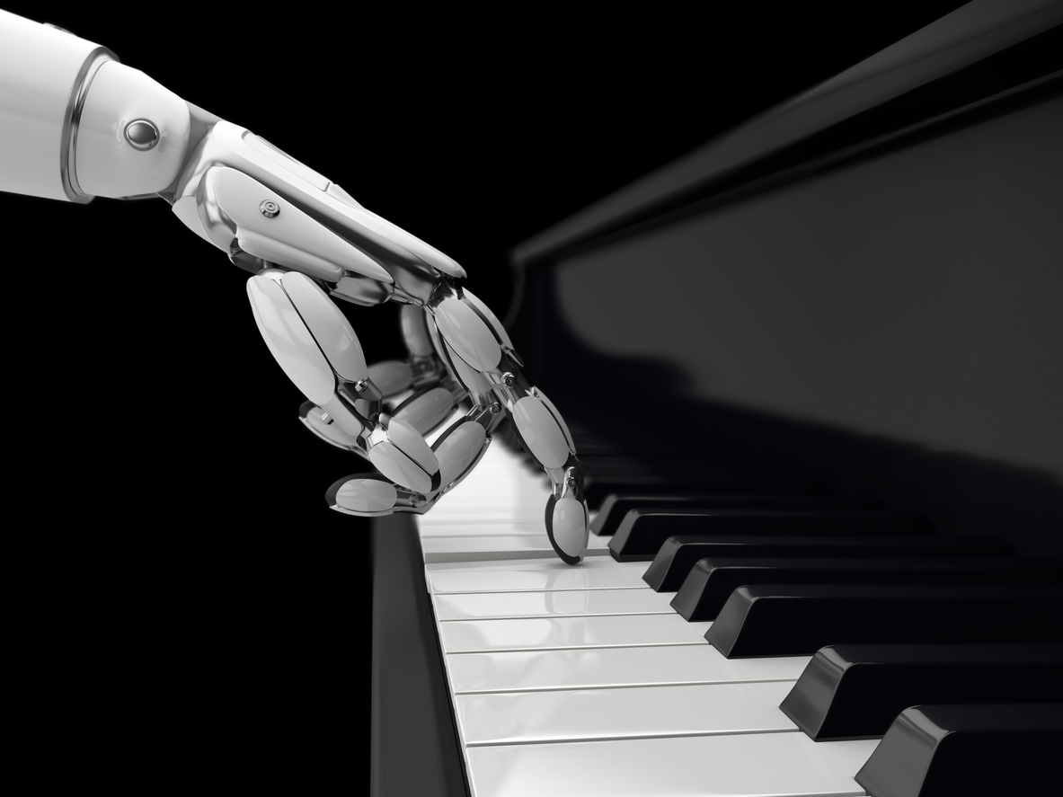 Robot plays a key on piano.